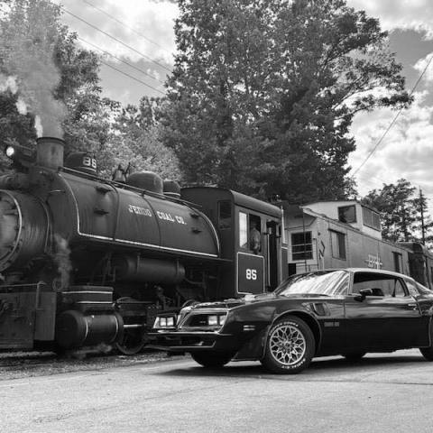 a steam engine train traveling down train tracks