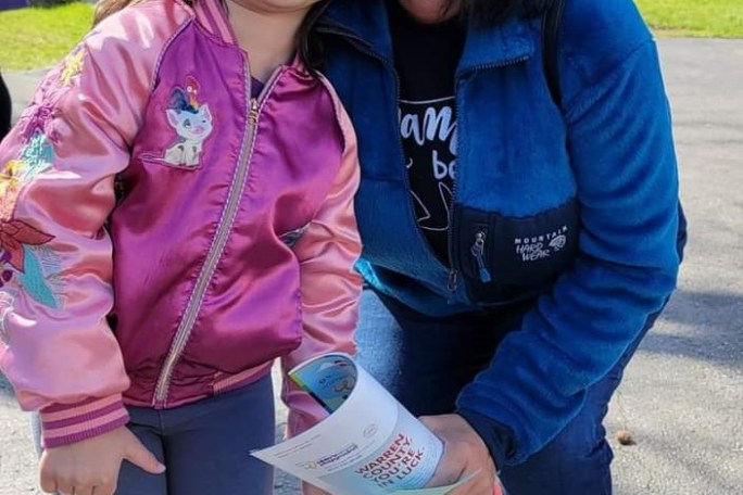 a woman and a little girl posing for a picture with bunny ears