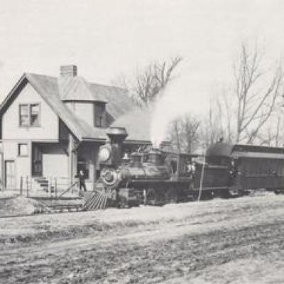 a vintage photo of a dirt field with a train