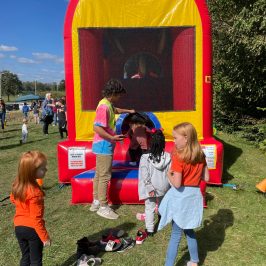 a group of people that are standing in the grass