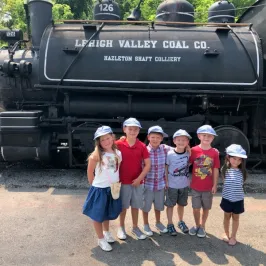 a group of people standing in front of a train