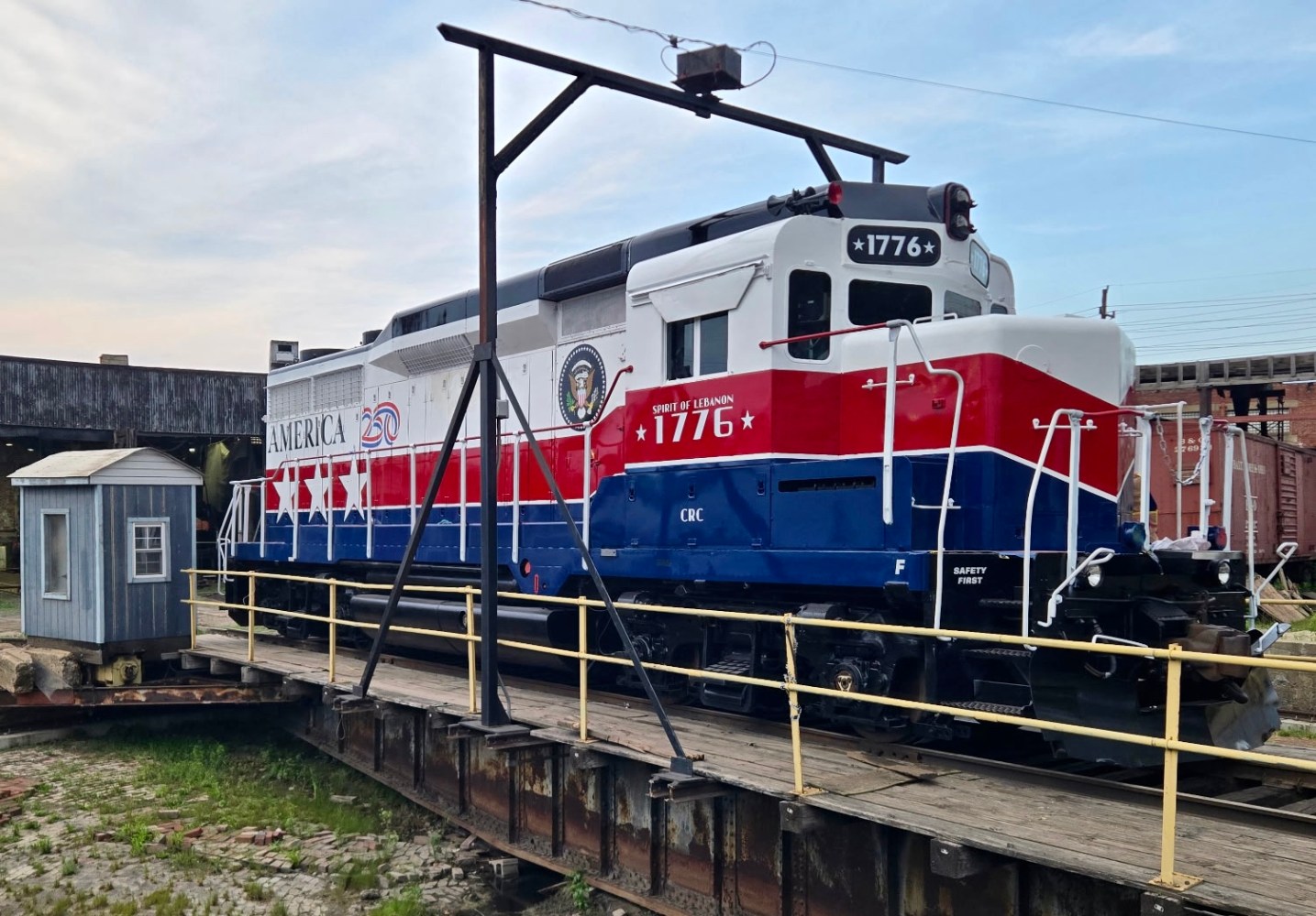 Patriotic train on turntable, painted red, white, and blue with number 1776.